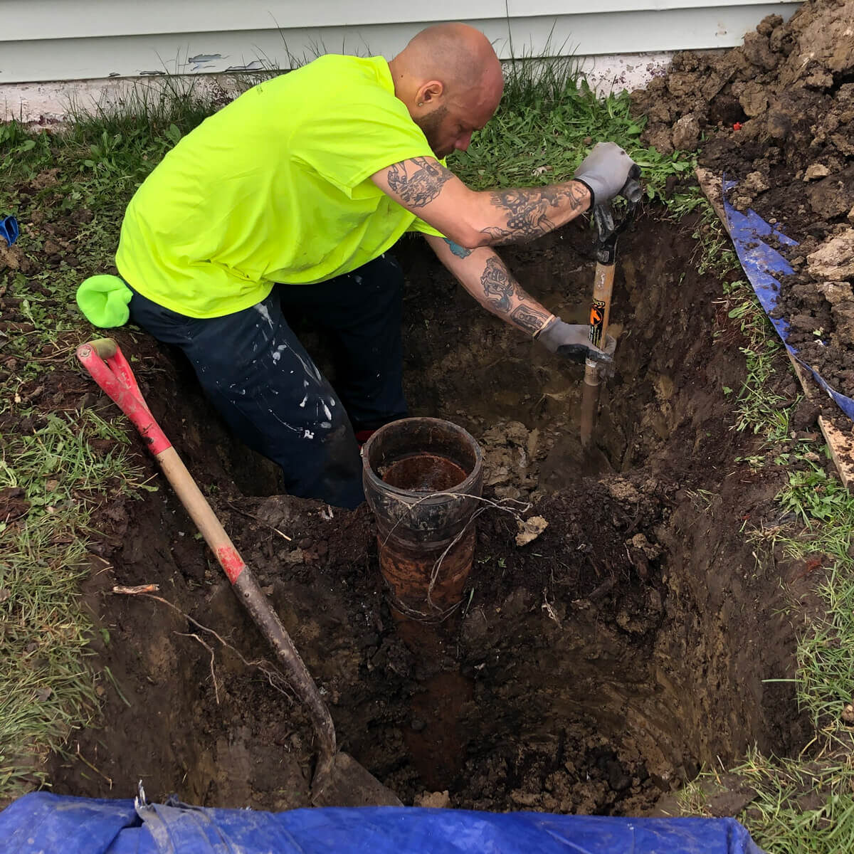 Worker Fixing Sewer Line Pipe